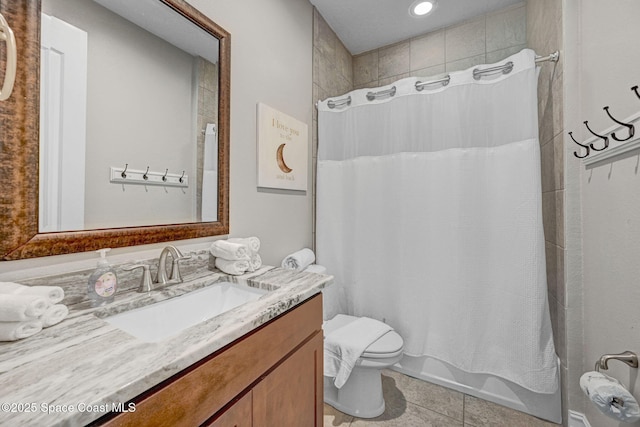 full bathroom featuring tile patterned floors, vanity, toilet, and shower / bath combo with shower curtain