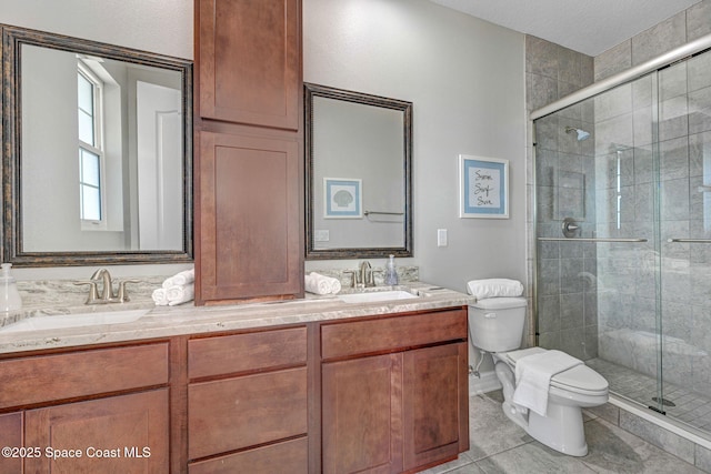 bathroom with an enclosed shower, vanity, tile patterned floors, and toilet