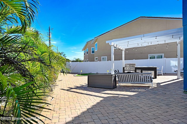 view of patio / terrace featuring area for grilling, a grill, a pergola, and a bar