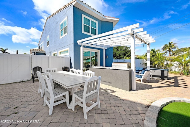 view of patio with a pergola and an outdoor kitchen