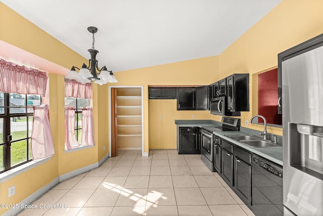 kitchen featuring stainless steel appliances, sink, a notable chandelier, pendant lighting, and a healthy amount of sunlight