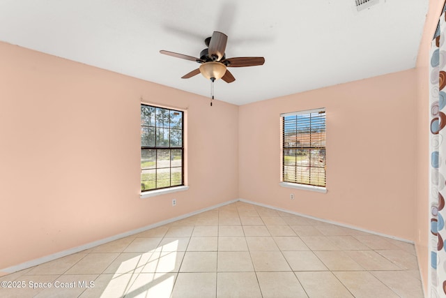 spare room featuring light tile patterned floors and ceiling fan