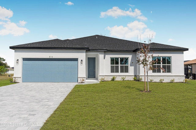 view of front of home with a garage and a front lawn