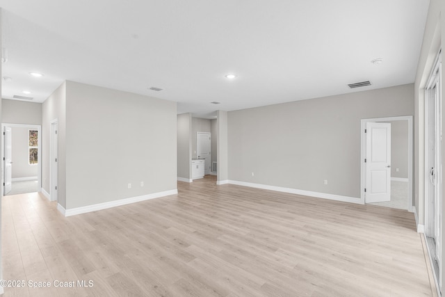 unfurnished room with light wood-type flooring