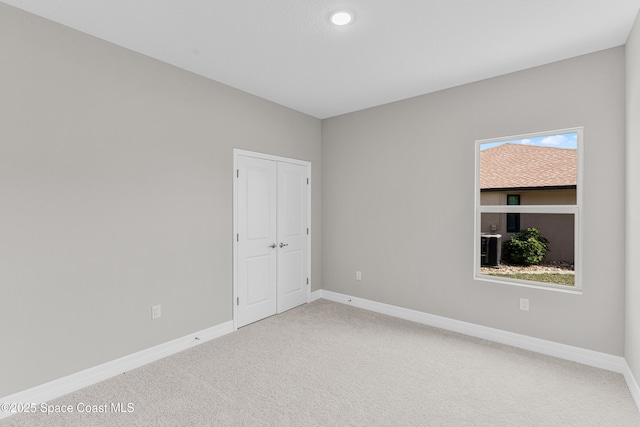 unfurnished room featuring carpet