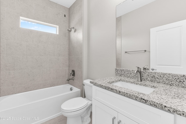 full bathroom featuring tiled shower / bath, vanity, and toilet