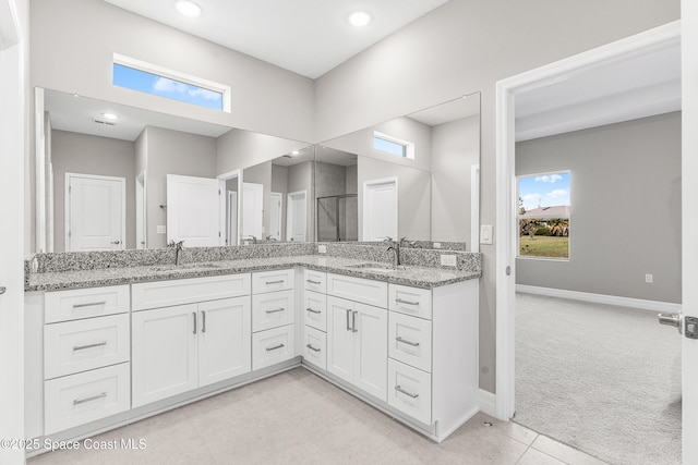 bathroom featuring vanity, tile patterned flooring, and a healthy amount of sunlight