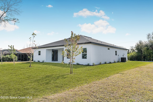 rear view of house featuring a yard and cooling unit