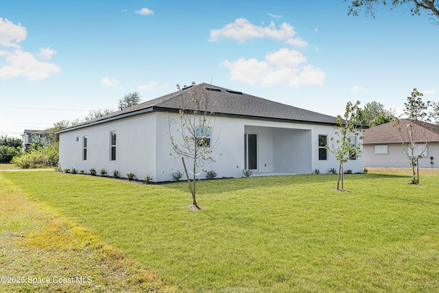 rear view of house featuring a yard