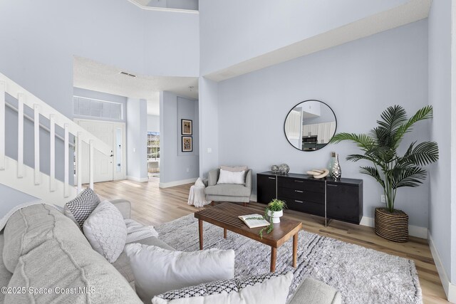 living room featuring hardwood / wood-style floors and a high ceiling