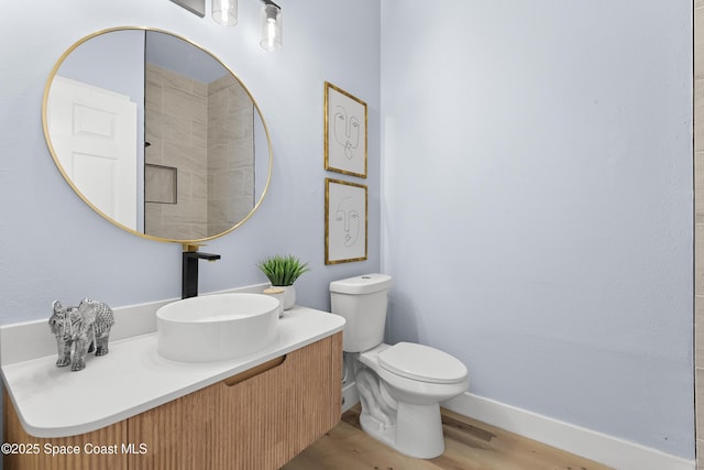 bathroom with vanity, hardwood / wood-style floors, and toilet