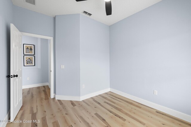 unfurnished room with ceiling fan and light wood-type flooring