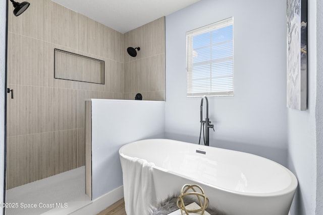 bathroom featuring shower with separate bathtub