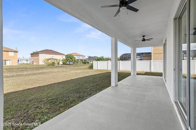 view of yard with ceiling fan and a patio area