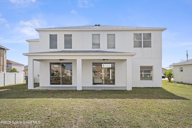 rear view of property with a patio area, ceiling fan, and a lawn