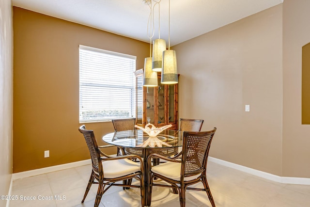 dining room featuring light tile patterned flooring and baseboards