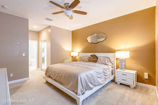 bedroom featuring light carpet, visible vents, ensuite bath, and baseboards