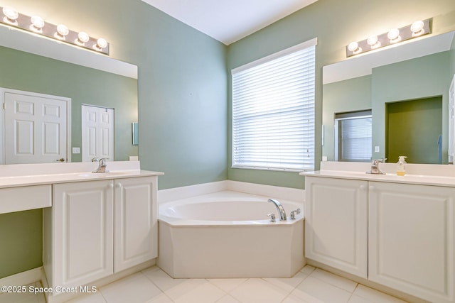 full bath with a garden tub, two vanities, a shower stall, and a sink