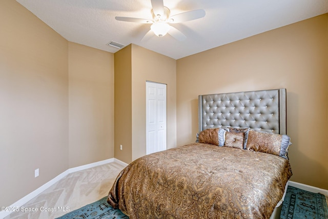 bedroom featuring visible vents, light carpet, baseboards, and ceiling fan