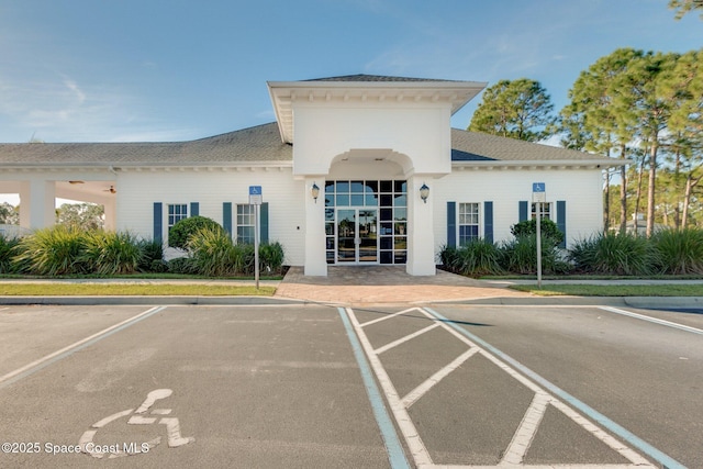 view of building exterior with uncovered parking