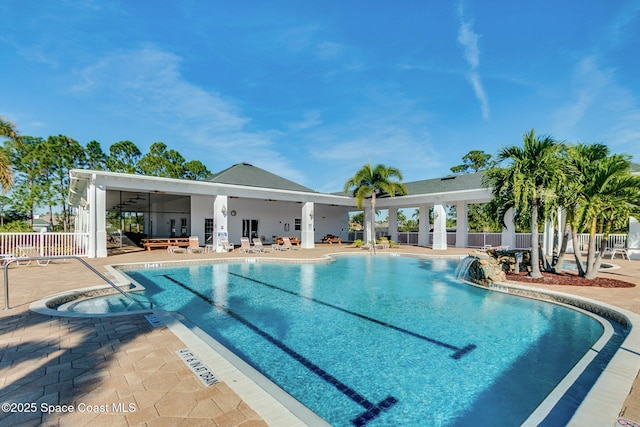 community pool featuring a patio and fence