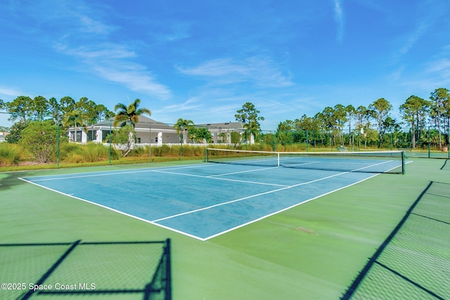 view of tennis court featuring fence