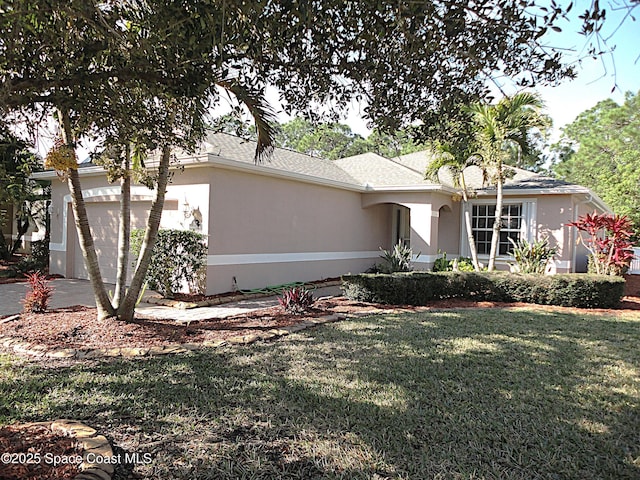 ranch-style house featuring a front yard, concrete driveway, a garage, and stucco siding