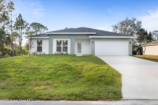 view of front of house with a garage and a front lawn