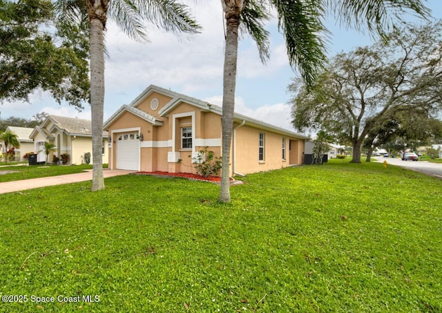 single story home with a garage and a front lawn