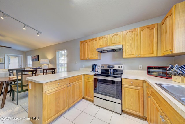 kitchen featuring sink, light tile patterned floors, ceiling fan, stainless steel range with electric cooktop, and kitchen peninsula