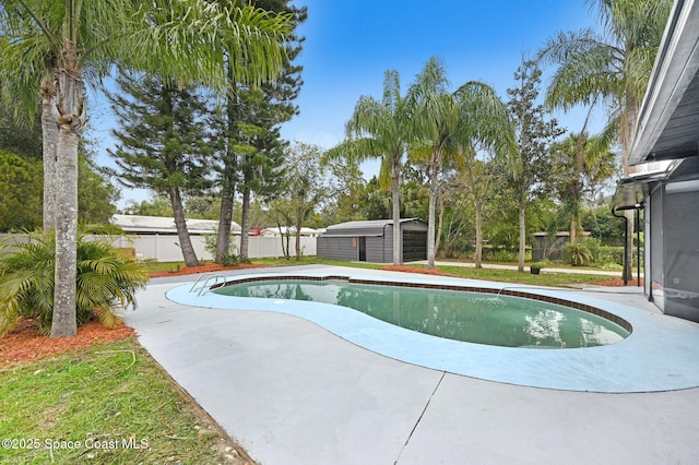 view of swimming pool featuring a storage shed