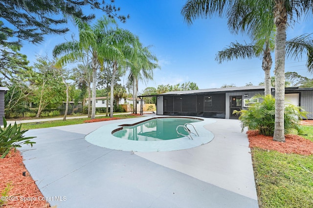 view of swimming pool featuring a patio area and a sunroom