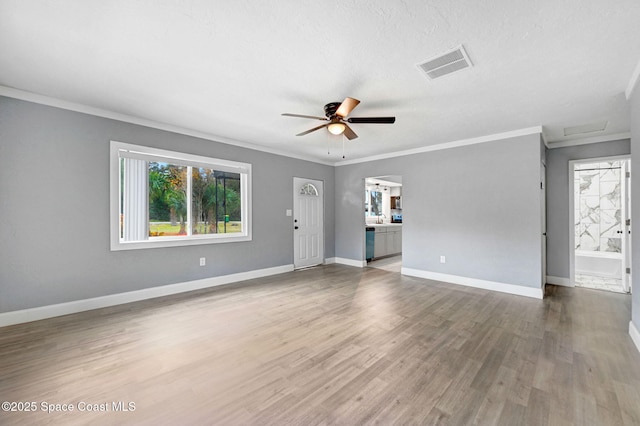 unfurnished living room featuring ornamental molding, hardwood / wood-style floors, a textured ceiling, and ceiling fan