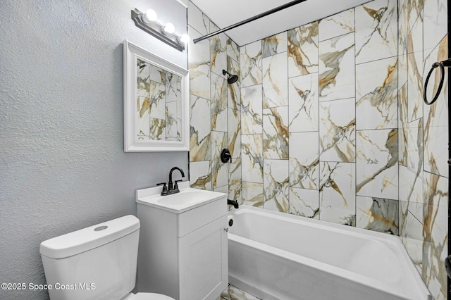 full bathroom featuring vanity, tiled shower / bath combo, and toilet