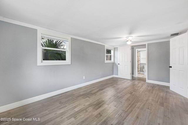 empty room featuring hardwood / wood-style flooring and ceiling fan