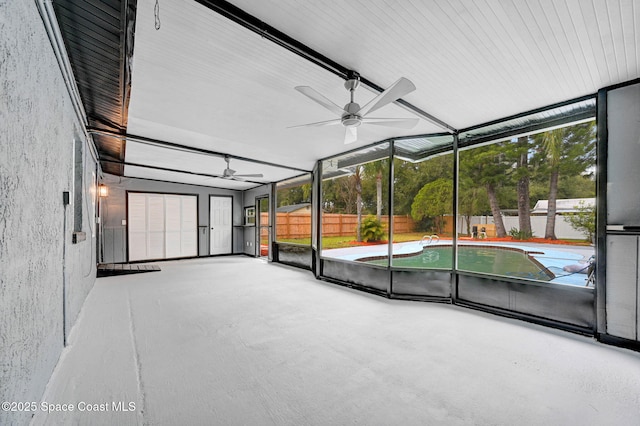 unfurnished sunroom with ceiling fan