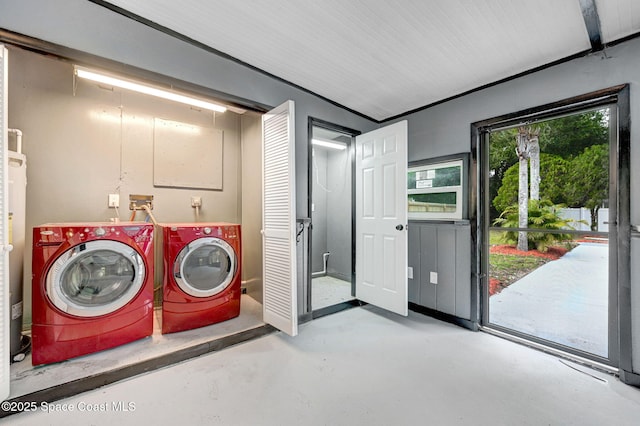 clothes washing area with washing machine and dryer