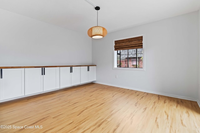 spare room featuring light wood-type flooring