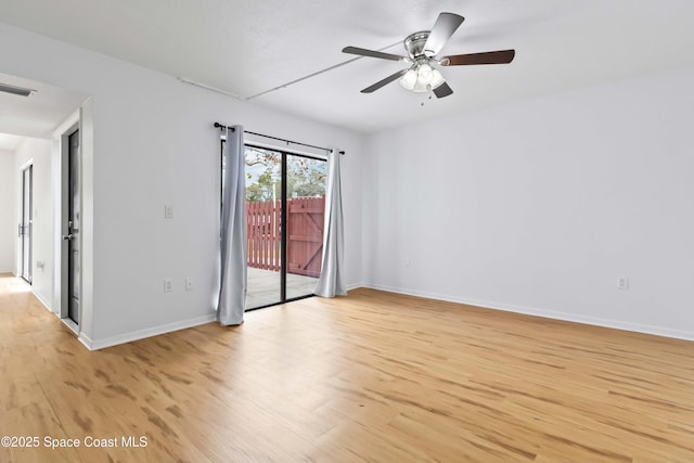 empty room featuring ceiling fan and light hardwood / wood-style flooring