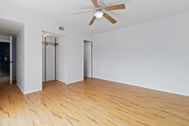 unfurnished bedroom with ceiling fan, a closet, and light wood-type flooring