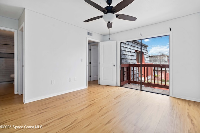 unfurnished bedroom featuring access to outside and light hardwood / wood-style floors