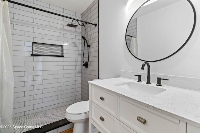 bathroom featuring a shower with curtain, vanity, and toilet