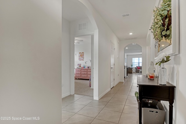 hall featuring light tile patterned flooring