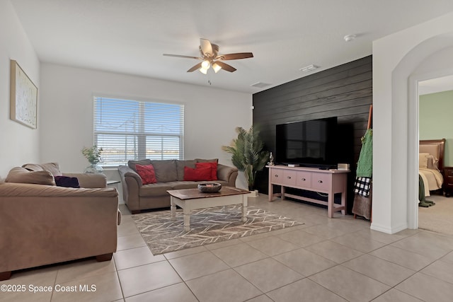 tiled living room with ceiling fan