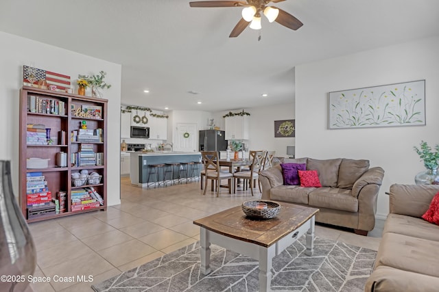 tiled living room featuring ceiling fan