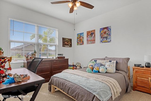 bedroom featuring light colored carpet and ceiling fan