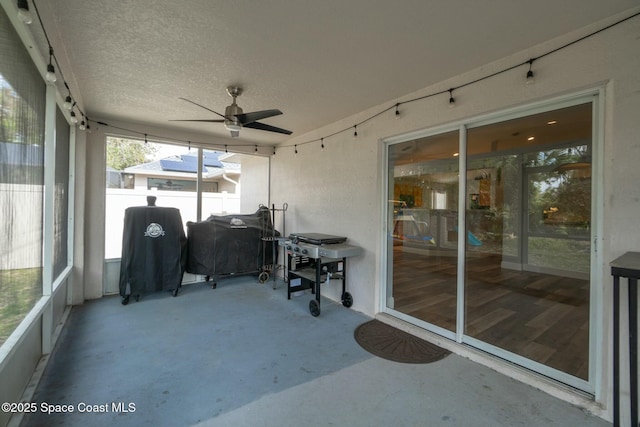 sunroom / solarium featuring ceiling fan