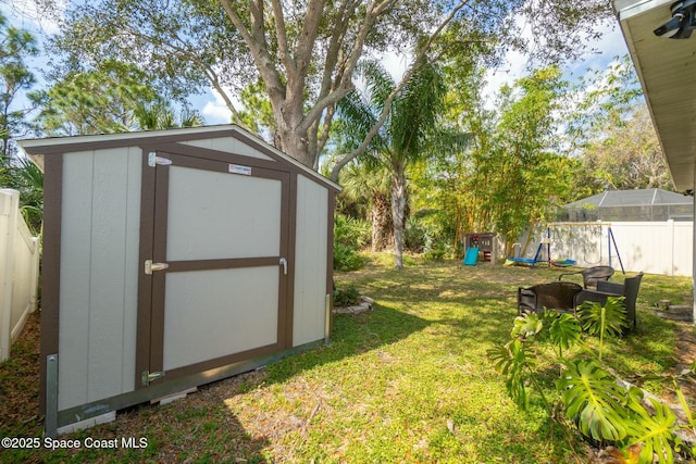 view of yard with a playground and a shed