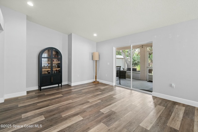 unfurnished living room with dark hardwood / wood-style flooring