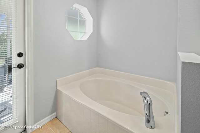 bathroom featuring a relaxing tiled tub, tile patterned floors, and plenty of natural light